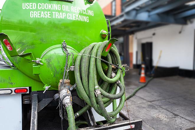 grease trap being pumped out by service technician in Burke, VA